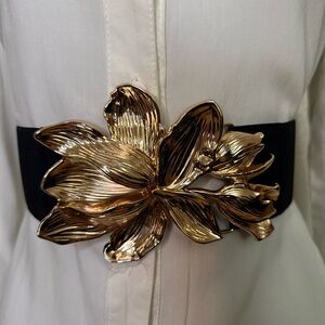 Black elastic waistband belt with gold tone flower buckle